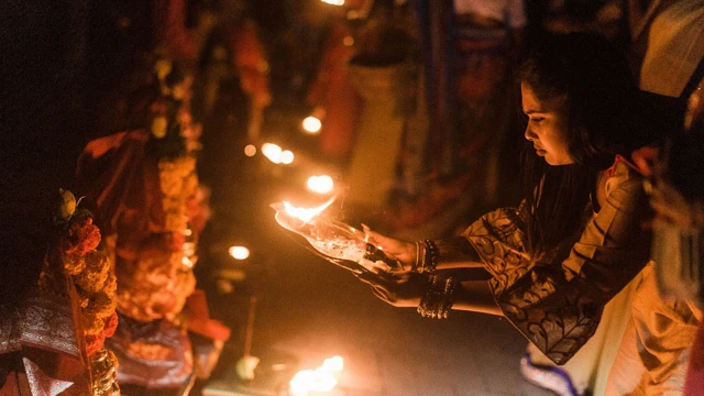 A woman makes a fiery offering in a Hindu ceremony in Durban, South Africa - Saturday 12 March 2022