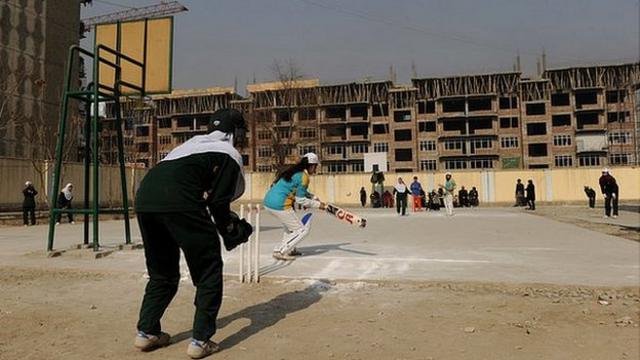 Afghan girls play cricket on the school grounds in Kabul on December 28, 2010