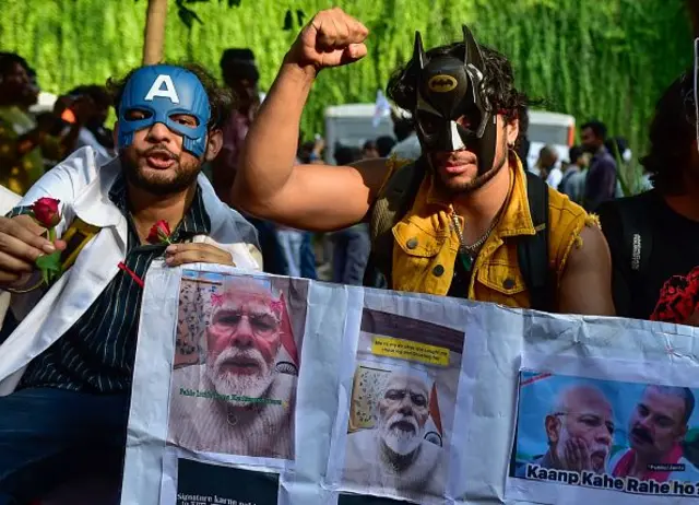 Gen-Z protesters wearing superhero masks hold posters depicting Indian Prime Minister Narendra Modi during an ongoing demonstration at Jantar Mantar on July 24, 2026 in New Delhi, India. 