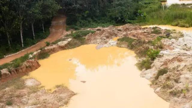 An uncovered pit from illegal mining 