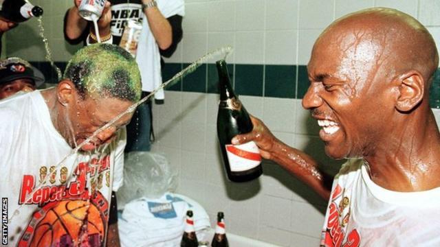 Dennis Rodman and Michael Jordan spray champagne