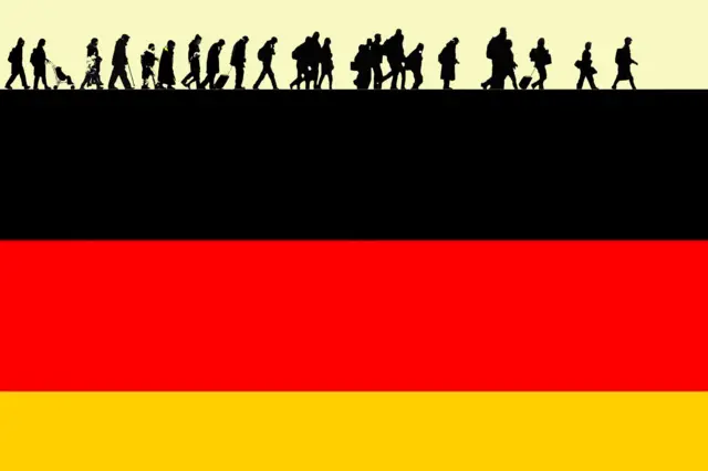 صورة لعلم ألمانيا وعليه رسم للاجئين 