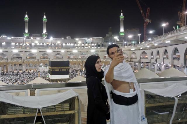 Muslim pilgrims take a selfie at the Grand Mosque in the holy Saudi city of Mecca, early on August 30, 2017, on the eve of the start of the annual Hajj pilgrimage. For the faithful it is a deeply spiritual journey, which for centuries every capable Muslim has been required to make at least once in their lifetimes. In the age of social media and live video streaming, it's now also an experience to be shared in real time.