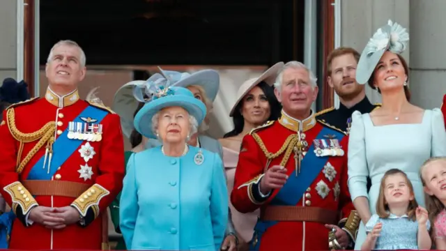 The British royal family watches a military air show from the balcony of Buckingham Palace