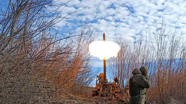 A Russian howitzer fires on Ukrainian positions