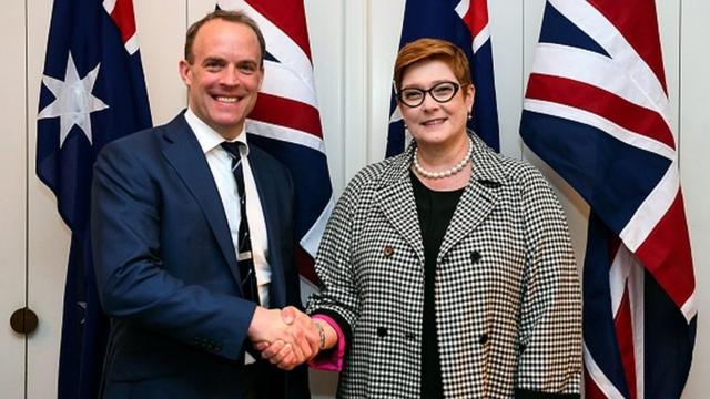Australia's Foreign Minister Marise Payne shakes hands with Britain's Foreign Secretary Dominic Raab