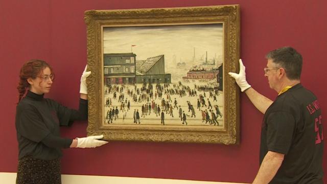 LS Lowry Going to the Match painting rehung in Salford