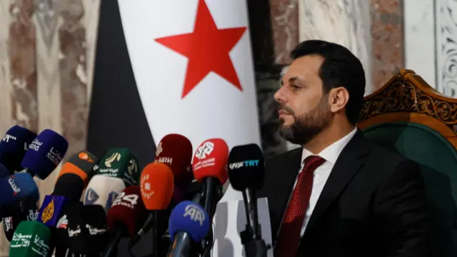 Suriye Halk Meclisi Seçimleri Yüksek Komitesi Başkanı Muhammed Taha el-Ahmed (solda), Şam'daki Halk Meclisi binasında düzenlenen basın toplantısında dinliyor (1 Temmuz 2026).