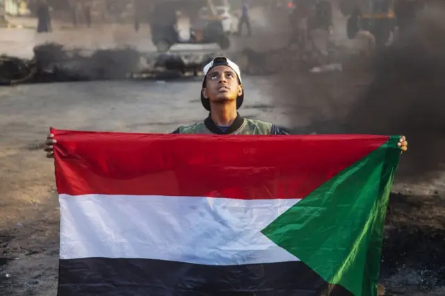 Sudanese people block roads and protest against Monday's coup.