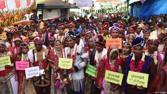 Indian couples pose for a photograph during a mass wedding for members of the Adivasi Bhil tribal community in Ahmedabad on February 11, 2018.