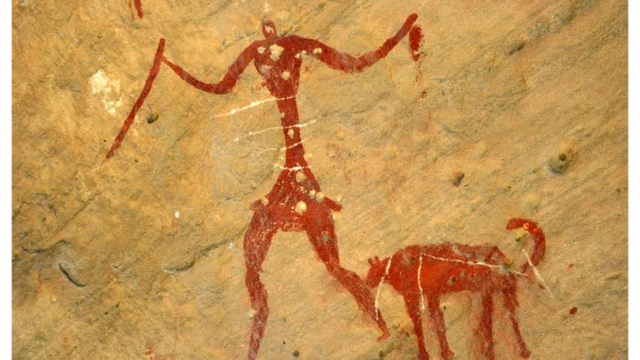 Cave painting of a hunter and what is believed to be his dog
