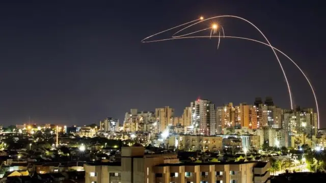 Streaks of light are seen as Israel's Iron Dome anti-missile system intercepts rockets launched from the Gaza Strip towards Israel