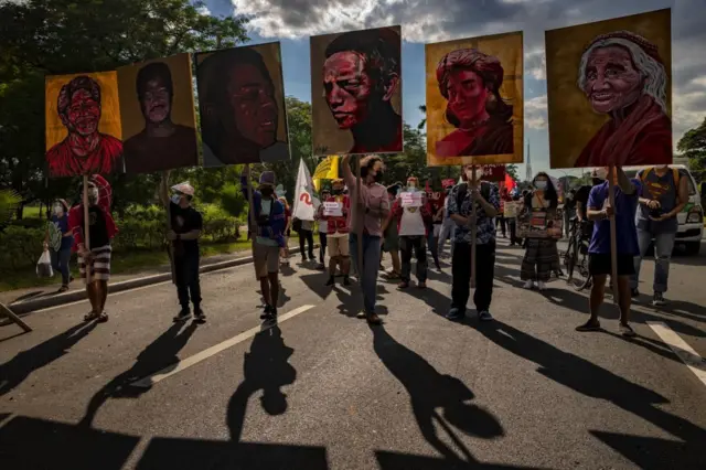 Climate activists hold up portraits of slain Philippine environmental defenders as they take part in a Global Day of Action for Climate Justice protest on November 06, 2021 in Quezon city, Metro Manila, Philippines.