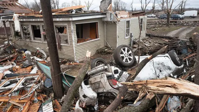 A home is reduced to rubble after being hit by yesterday's tornado on March 11, 2026 in Aroma Park, Illinois.
