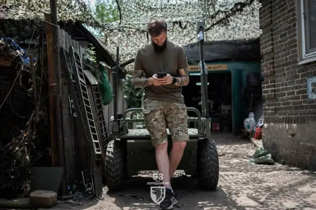 Хлопець сидить на наземного роботизованому комплексі