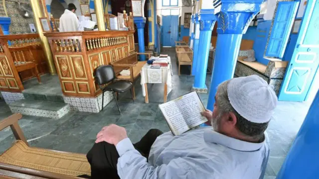 Homens judeus tunisianos rezam em uma sinagoga em Djerba, durante a peregrinação anual judaica
