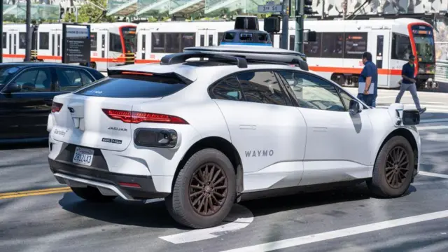Một chiếc xe tự lái của Waymo dừng lại tại lối băng qua dành cho người đi bộ ở San Francisco.