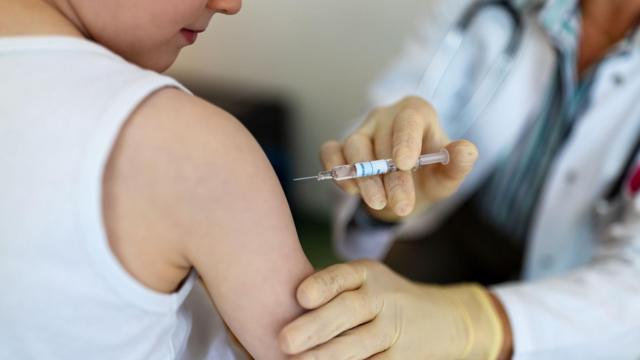Menino sendo vacinado no braço