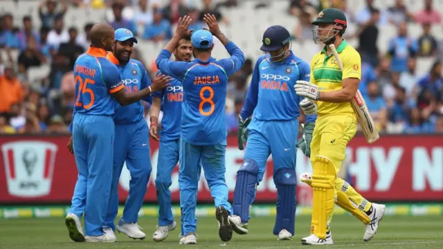 India players celebrate after claiming the wicket of Marcus Stoinis of Australia during game three of the One Day International series between Australia and India at Melbourne Cricket Ground on January 18, 2019 in Melbourne, Australia.