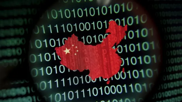 A map of China is seen through a magnifying glass on a computer screen showing binary digits in Singapore in this January 2, 2014 file photo illustration.