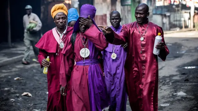 Members of the Legio Maria Church react while being affected by tear gas during clashes between the police and opposition supporters in Mathare, Nairobi, Kenya - Thursday 26 October 2017