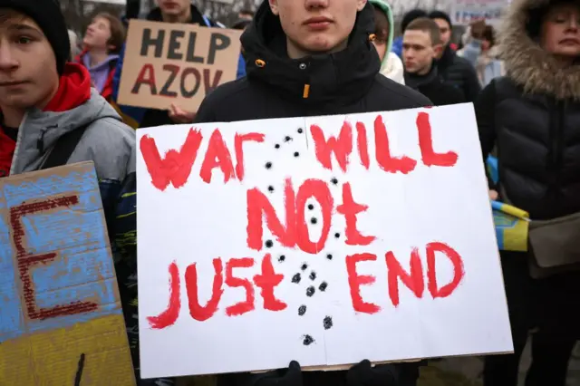 Протестувальник у Берліні з плакатом "Війна не закінчиться просто так