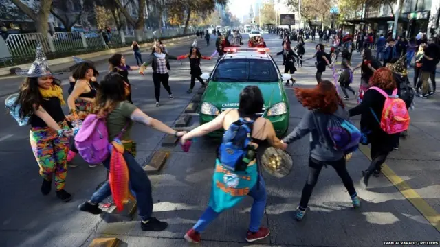 ਇੱਕ ਮੁਜਾਹਰੇ ਦੌਰਾਨ ਵਿਖਾਵਾਕਾਰੀ ਪੁਲਿਸ ਦੀ ਕਾਰ ਨੂੰ ਨੱਚਦੇ ਹੋਏ ਘੇਰਾਂ ਪਾਉਂਦੀਆਂ ਹੋਈਆਂ।