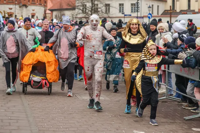 People dressed in funny costumes attend the traditional Krakow New Year's Run in the Old Town on the New Year's Eve in Krakow, Poland