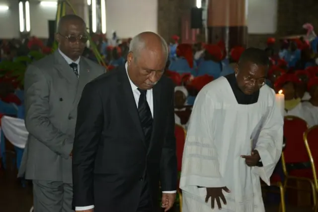 Le ministre camerounais de la Justice, Laurent Esso (à gauche), rend hommage lors des funérailles de Mgr Jean-Marie Benoit Bala.