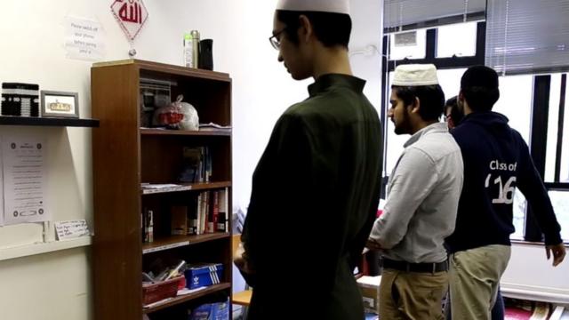 香港大学的穆斯林学生在祈祷室做礼拜。女性祈祷室在同一空间以黑布隔开。