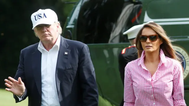 U.S. President Donald Trump waves as he with First Lady Melania Trump and their son Barron walk on South Lawn of the White House upon their return to Washington, U.S., from Camp David, August 27, 2017.