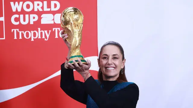 La presidenta de México Claudia Sheinbaum sostiene la Copa Mundial de fútbol