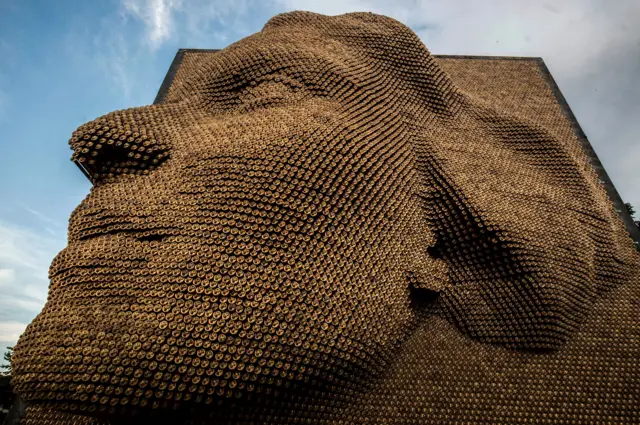 The Heroines memorial in Pristina depicts a woman's face in relief 