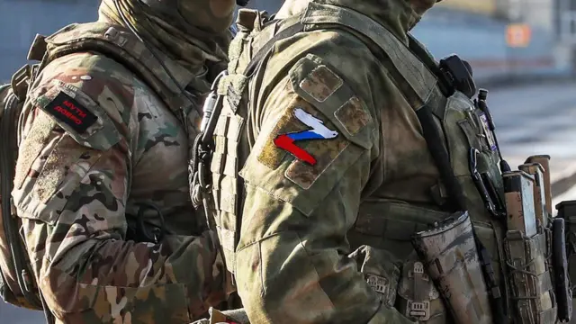 Russian servicemen stand guard near the Kakhovka Hydroelectric Power Plant near Kherson, Ukraine - 20 May 2022