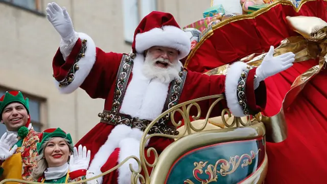 Santa Claus waves from his flotat during the annual Macy's Thanksgiving Day Parade in New York City, November 28, 2019