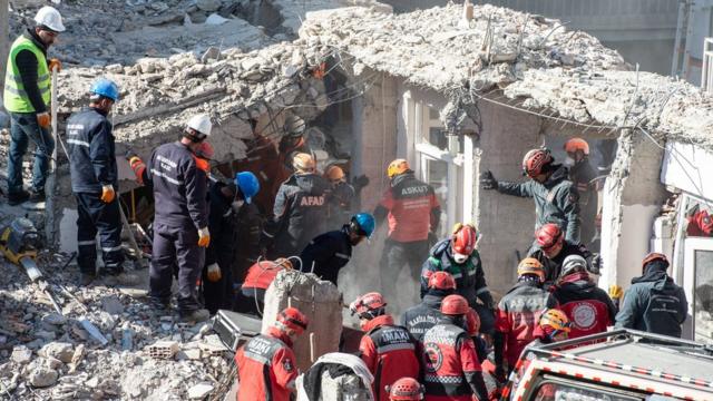 Rescue workers work at the scene of a collapsed building on 26 January 2020 in Elazig, Turkey.