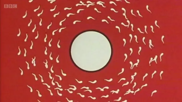 Captura de tela com desenho de um óvulo rodeado por espermatozoides nadando, com fundo vermelho