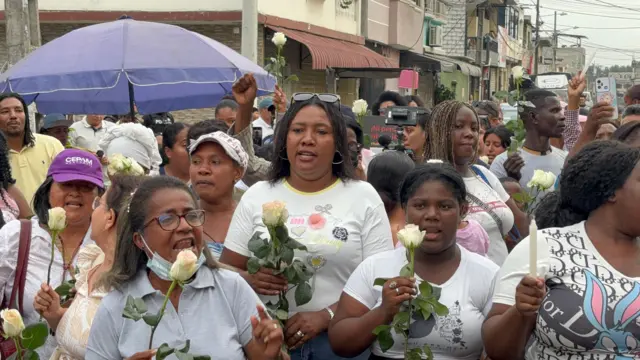 Mujeres portando rosas blancas en el chigualo.