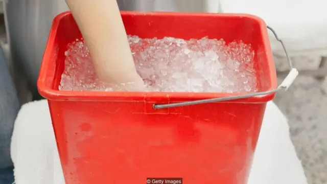Mano en cubeta de hielo.