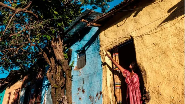 A woman points out from a house in Gondar, Ethiopia, on November 23, 2020.
