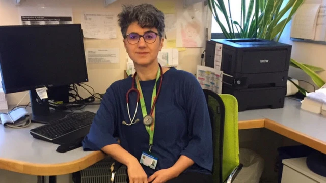 Dr Roghieh Dehghan sitting at her desk