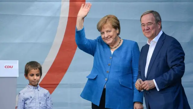 Christian Democratic Union (CDU) party chairman and top candidate for the upcoming federal elections Armin Laschet (R) and German Chancellor Angela Merkel (L) during the election campaign closing of the CDU in Aachen, Germany, 25 September 2021
