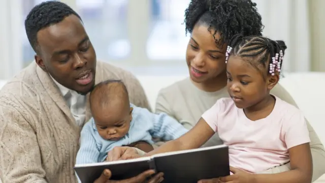 Papa, mama and children dey read book