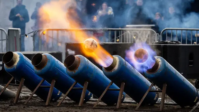 In Ommen, the Netherlands, milk cans fire footballs out the end of with lots of fire.