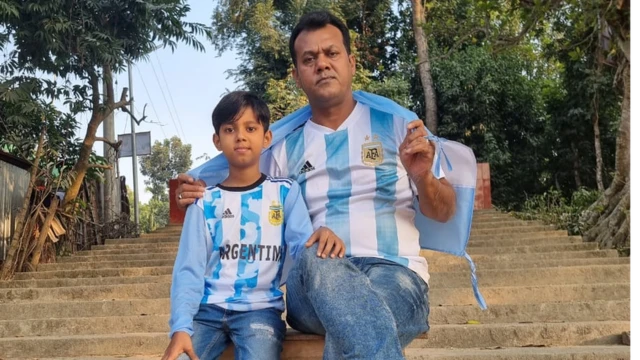 Mashiur Rahman and his son Nafi sat together in football shirts