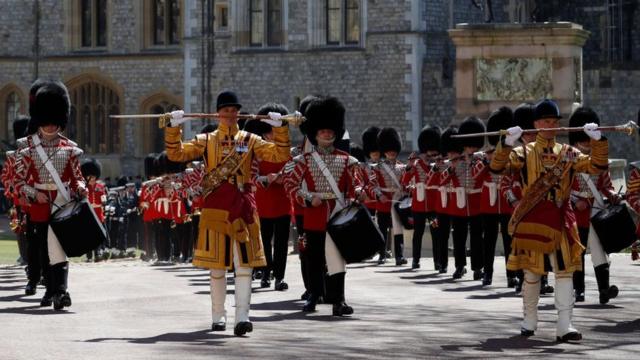 Members of a military band march into position at Windsor Castle in Windsor, west of London, on April 17, 2021, prior to the funeral service of Britain's Prince Philip, Duke of Edinburgh