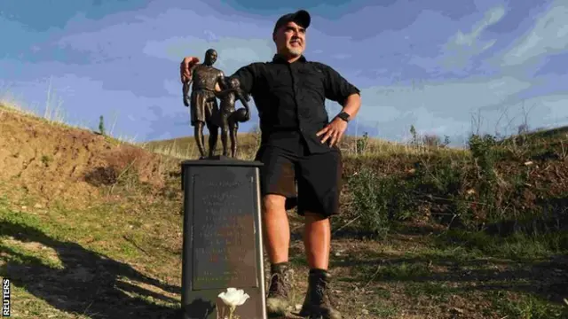 Sculptor Dan Medina with statue