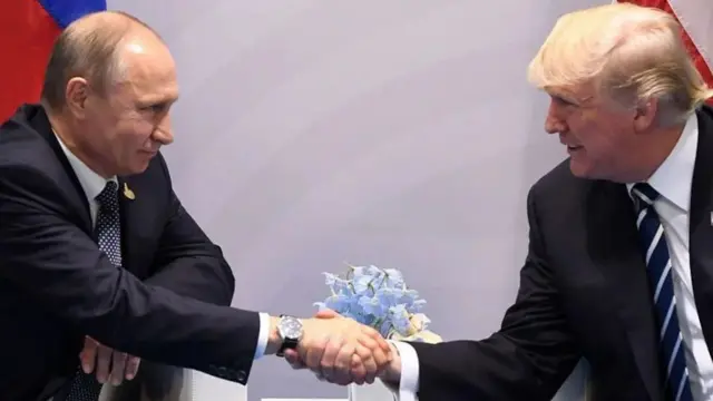 Donald Trump and Vladmir Putin shake hands