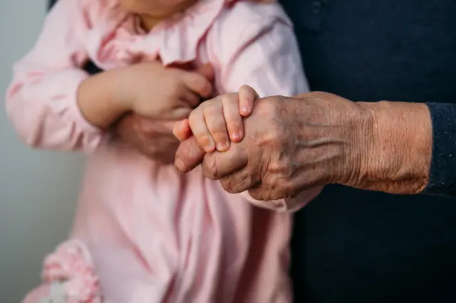 bebê segura uma mãoesporte da sorte miniadulto