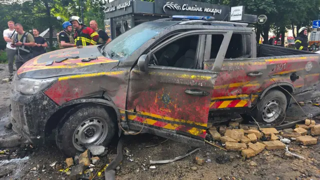 A damaged emergency vehicle struck by a massive overnight attack in Kyiv